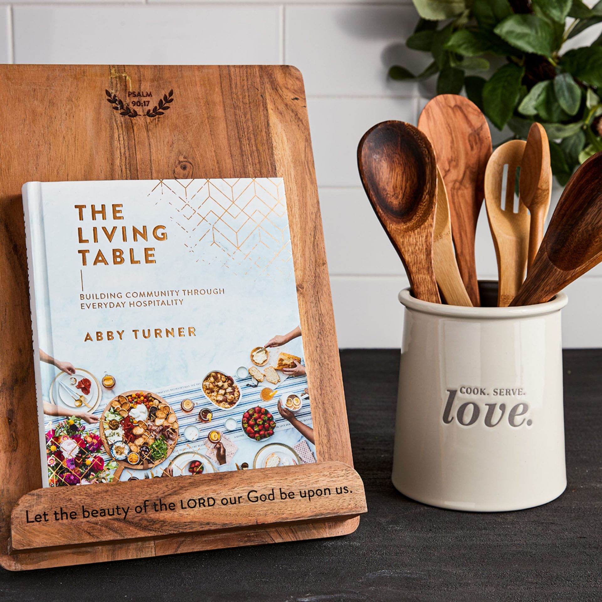 The Living Table cookbook on stand with utensil caddy